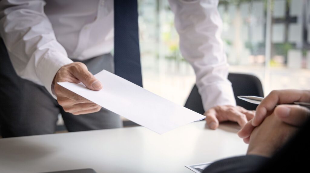 A man submitting a letter to his superior on the topic for appointment and resignation of directors. 
