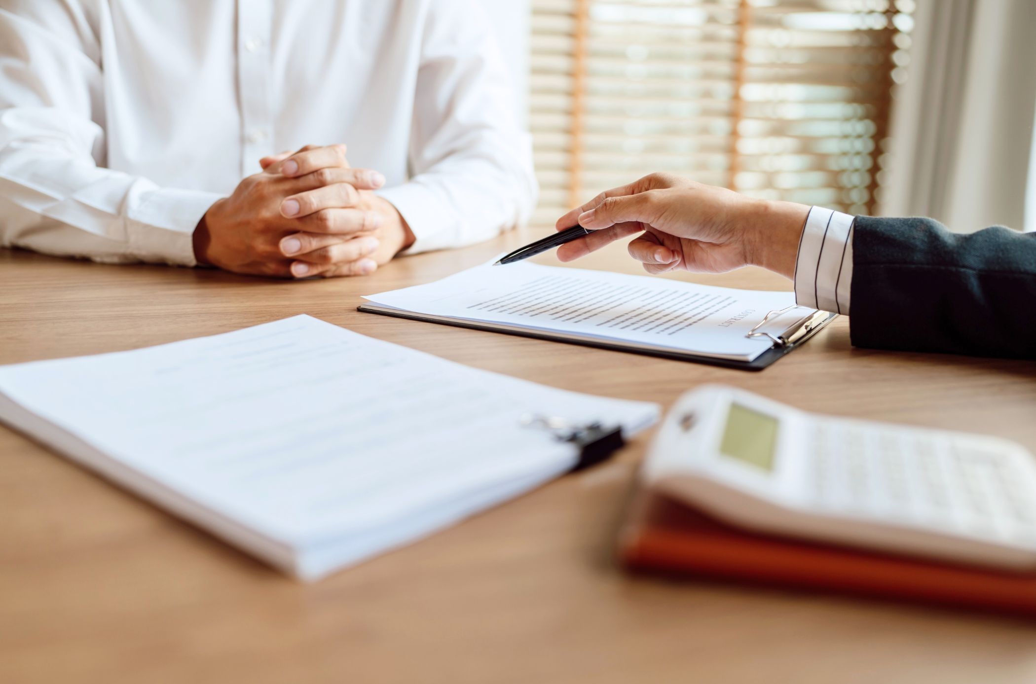 A company’s members studying shareholders agreements to approve a share transfer.