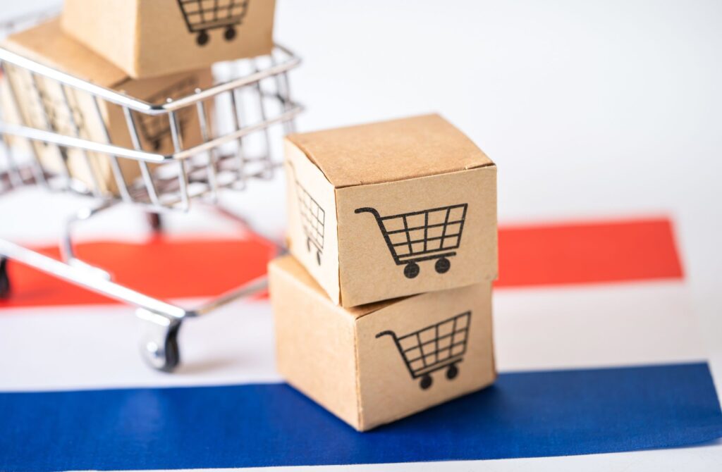 Cardboard boxes stacked on top of a shopping cart.